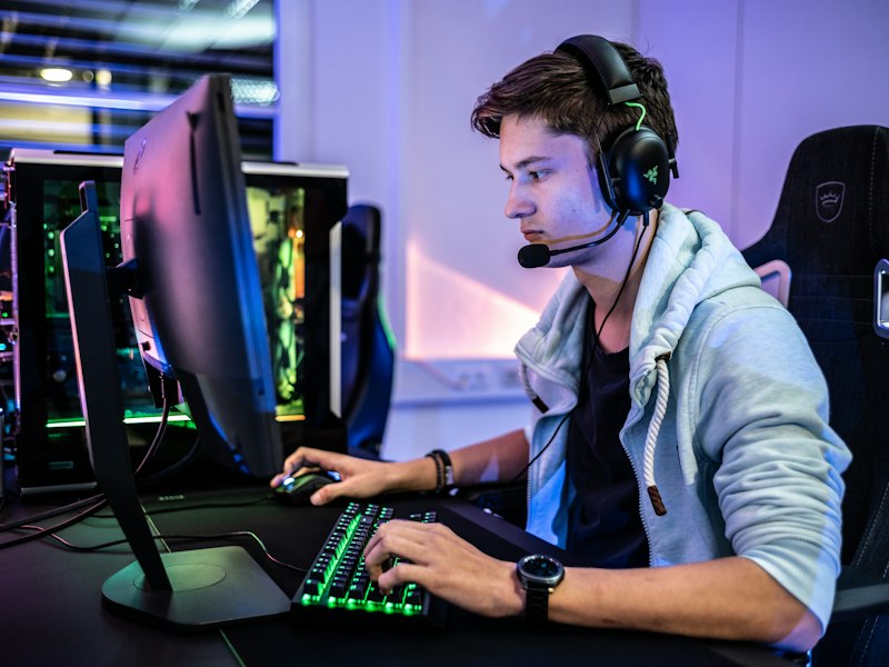 Late-night gaming setup lit in teal